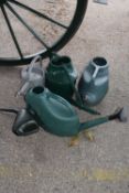 Five various watering cans
