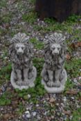 Pair of composite seated lions, height approx 45cm