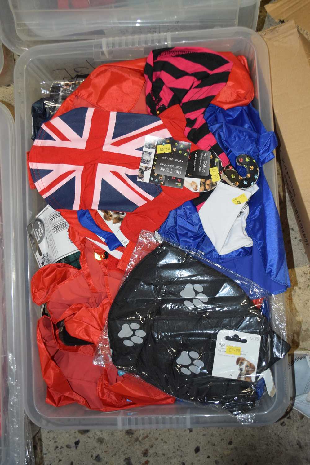 Boxed containing a mixture of pet T-shirts and pet jackets