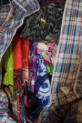 Bag containing a mixture of umbrellas and other clothing items