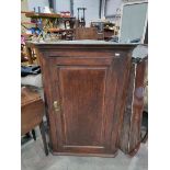 A George III oak corner hanging cupboard with sing