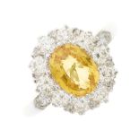 A platinum yellow sapphire and diamond cluster ring
