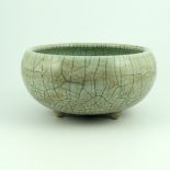 An 18th Century Chinese celadon crackle glaze censor, of bombe form, on triple dimple feet, height