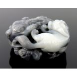 A Chinese black and white jade pendant carving, in the form of large and small shi-shi, diameter 5cm