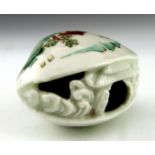 A Japanese Hirado porcelain netsuke, Meiji period, 1868-1912, in the form of a clam with internal