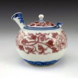 A Japanese Hirado porcelain teapot, Meiji period, 1868-1912, underglaze blue and copper red floral