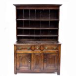 A George II country oak dresser, circa 1740 and later, plain cornice, overhanging upper section to