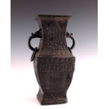 A 19th Century Chinese bronze baluster vase, of square section, zoomorphic and ring handles,