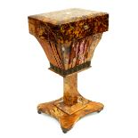 A Regency blonde tortoiseshell pedestal work table, circa 1820, hinged cover opening to a fitted