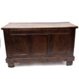 A late 17th Century oak chest, chip carved and moulded top, triple panel front with lozenge carved