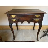 A George II country oak lowboy, circa 1750, moulded top, single long frieze drawer with two short