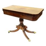 A Regency mahogany pedestal games table, circa 1820, fold-over top with green baize lined surface,