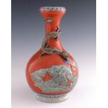 A 19th Century oriental baluster vase, the body with applied dragon in relief over a seascape with