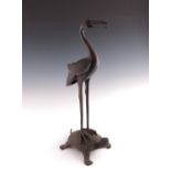 A Japanese bronze model of a stork standing upon a turtle, Meiji period, 1868-1912, realistic