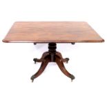 A Regency mahogany breakfast table, circa 1820, rectangular moulded tilt-top, baluster pedestal,