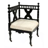 An Aesthetic Movement ebonised corner chair, in the style of Christopher Dresser