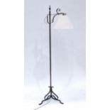 An Arts & Crafts wrought iron height adjustable library floor lamp, urn finial, overhanging lamp