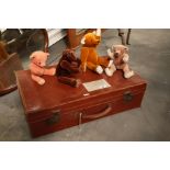 A leather suitcase, together with four teddy bears