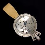 R E Stone, an Art Deco silver and ivory commemorative tea strainer, London 1935