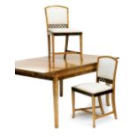 An Art Deco birchwood/sycamore pull out dining table and eight chairs