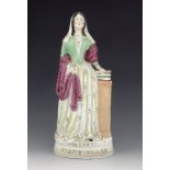 A Staffordshire figure of Florence Nightingale, titled 'Miss Nightingale', circa 1855, modelled stan