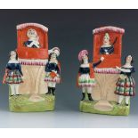 A pair of Staffordshire puppet show figure groups of Punch and Judy, circa , each modelled in orange