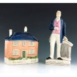 A Staffordshire figure of 'William Palmer', circa 1855, modelled standing beside a plinth with a scr