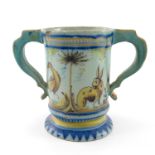 An Italian maiolica loving cup, late 18th/early 19th Century, of silver shape painted in typical