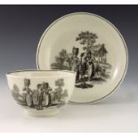 A Worcester black transfer decorated tea bowl and saucer