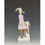 A Staffordshire figure of 'Henry V Trying on the Crown', circa 1847, modelled standing, placing the