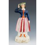 A Staffordshire theatrical figure of Jenny Lind, circa 1847, modelled standing, her right hand touch