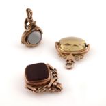 Three 9ct gold and hardstone set swivel seal fobs