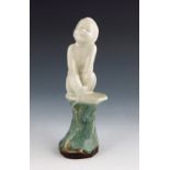 Leslie Harradine for Royal Doulton, a stoneware figure of a boy sitting on a plinth