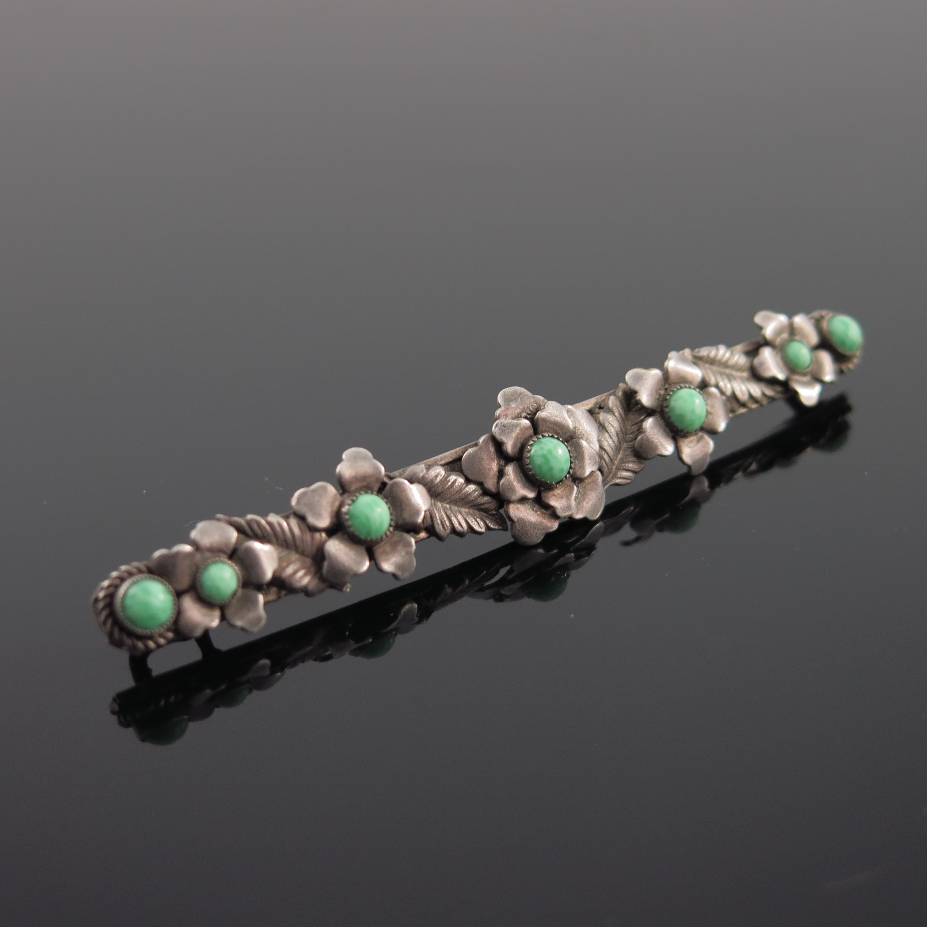 An Arts and Crafts white metal and green cabochon brooch, circa 1940s, bar form with applied - Image 2 of 3