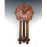 An Arts and Crafts copper and enamelled wall clock