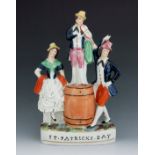 A Staffordshire pottery figure group titled ‘St Patrick’s Day’, circa 1860, modelled as a man standi