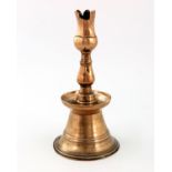 A Turkish Ottoman brass tulip candlestick