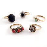 Four 9ct gold gem set dress rings, and a gold metal pearl and emerald set ring (indistinct marks)