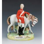 A Staffordshire figure of Sir Charles Napier, circa 1870, modelled standing beside his horse, wearin