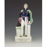 A Staffordshire figure of 'Sir De Lacy Evans', circa 1854, modelled standing beside a cocked hat on