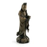 A Chinese carved wooden figure of Guanyin, late 19th or early 20th Century, modelled wearing robe