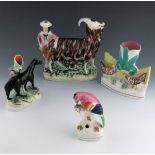 A selection of 19th Century Staffordshire animal figures, to include a spill vase modelled as a goat