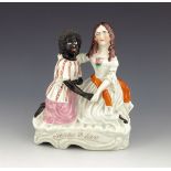 A Staffordshire figure of 'Topsy & Eva', circa 1870, modelled kneeling and holding hands, on a styli