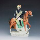 A Staffordshire figure of Garibaldi, circa 1870, modelled on horseback, wearing a stripe painted sha