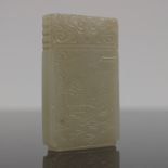 A Chinese pale jade bi, the front carved with a bearded man seated beside a pagoda, the reverse with
