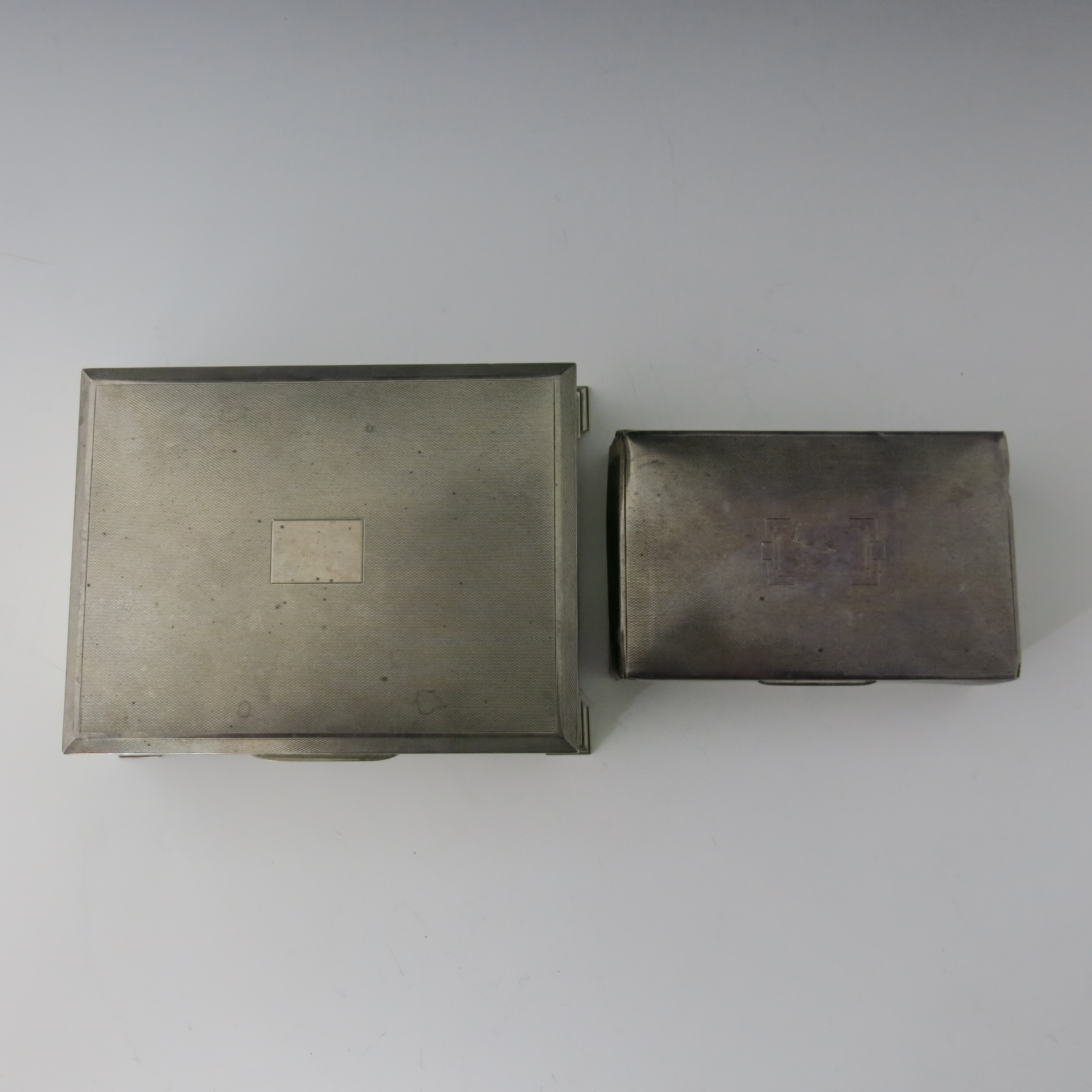 An Elizabeth II silver table cigarette casket, machine engraved cover, stepped bracket feet, maker - Image 4 of 5