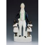 A Staffordshire figure of the Abolitionist John Brown, circa 1863, modelled standing between two sla