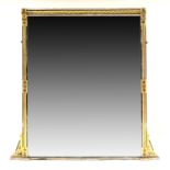 An Aesthetic Movement gilt framed overmantel, circa 1880, chamfered edges, black painted stylized