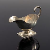 A George VI silver helmet shaped cream jug, Gladwin Ltd, Sheffield 1940, pedestal boat form, C