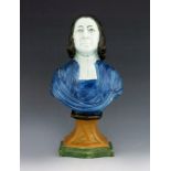 A Staffordshire pottery bust of John Wesley, circa 1825, polychrome enamel painted, on a pedestal ba